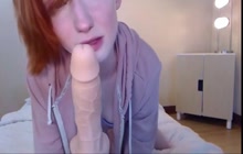 Redhead babe having fun with dildo and sucking it off