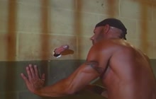 Muscled prisoner giving head trough gloryhole